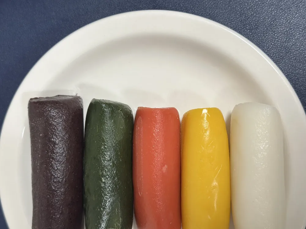 접시에 나란히 놓은 오색 가래떡. 다섯 가지 색의 가래떡이 가지런하다